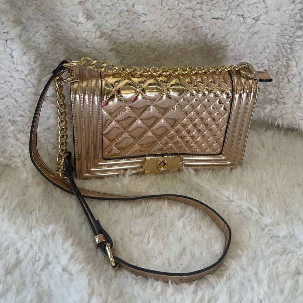Metallic Rose Gold quilted crossbody bag with adjustable strap.